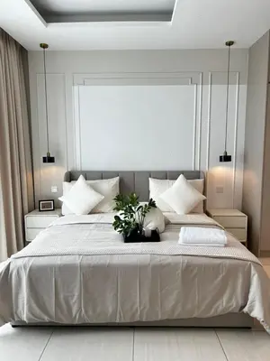 a bedroom with a large bed with white pillows at Modern Studio Escape in Kuala Lumpur