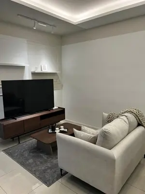 a living room with a couch and a flat screen tv at Modern Studio Escape in Kuala Lumpur