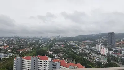 a view of a city with buildings and mountains at Cozy Studio Retreat in Kuala Lumpur