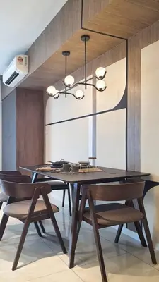 a dining room with a black table and chairs at Cozy Studio Retreat in Kuala Lumpur