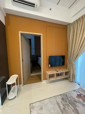 a living room with a television and a couch at Cheapest 2R2B in the Heart of KL in Kuala Lumpur