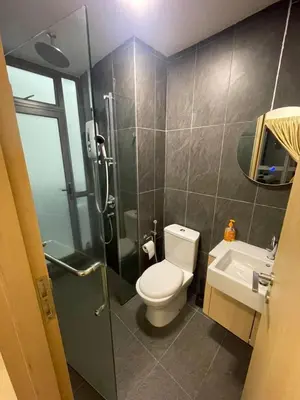 a bathroom with a toilet and a shower and a sink at The Colony Infinitum by Manila in Kuala Lumpur
