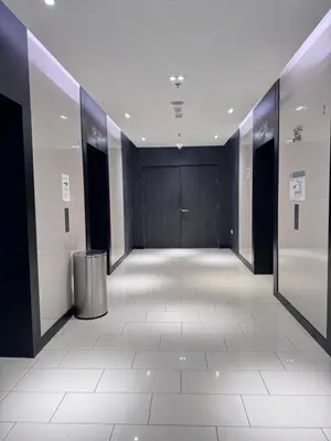 a hallway in a building with a trashcan in the middle at The Colony by Klcc Wisma Infinitum in Kuala Lumpur