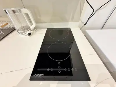 a black appliance on a white counter top at Majestic Calm 1BR Suite with Rooftop Infinity Pool in Kuala Lumpur