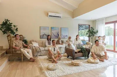 a group of people sitting in a living room at Provence Chateau Retreat 40 Pax Pool Villa Bangsar by Verano in Kuala Lumpur