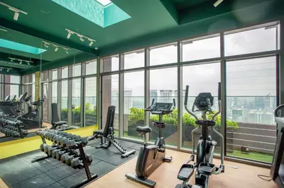a gym with treadmills and elliptical machines at Riveria Sky Residences KL Sentral with Infinity Pool in Kuala Lumpur