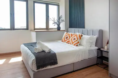 a bedroom with a bed with pillows on it at Riveria Sky Residences KL Sentral with Infinity Pool in Kuala Lumpur