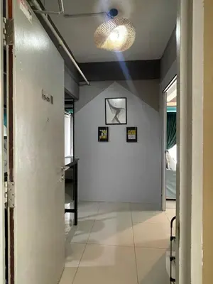 a hallway with a white wall and a light fixture at Nour Homestay KLCC View - COZY 1 in Kuala Lumpur