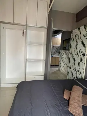 a bedroom with a bed and a closet at Nour Homestay KLCC View - COZY 1 in Kuala Lumpur