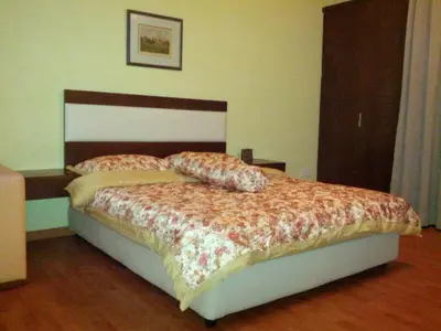 a bedroom with a bed with a floral comforter at Platinum Inn Bukitbintang in Kuala Lumpur