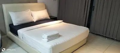 a bed with two towels on it in a room at Summer suite KLCC by Classic Stay in Kuala Lumpur