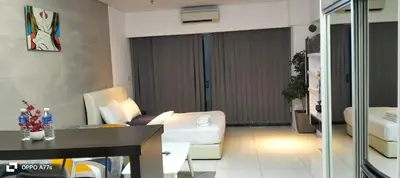 a living room with a white couch and a table at Summer suite KLCC by Classic Stay in Kuala Lumpur