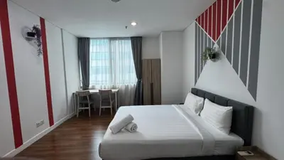 a bedroom with a bed and a table in a room at Mercu Summer Suites By comfort Home Stay in Kuala Lumpur