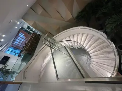 a spiral staircase in a building with a glass case at Mercu Summer Suites By comfort Home Stay in Kuala Lumpur
