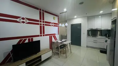 a kitchen with a television and a table in it at Mercu Summer Suites By comfort Home Stay in Kuala Lumpur