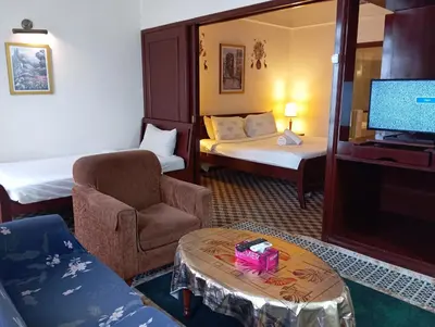 a hotel room with a tv and a chair and a table at Maritime Residence at Times Square KL in Kuala Lumpur