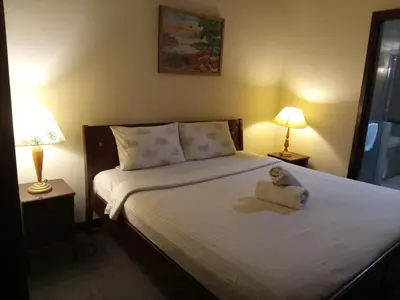 a bedroom with a bed with a towel on it at Maritime Residence at Times Square KL in Kuala Lumpur