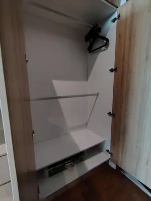 a closet with two shelves and a wooden door at Sky Suites Apartment service in Kuala Lumpur