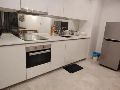a white kitchen with a sink and a refrigerator at Sky Suites Apartment service in Kuala Lumpur