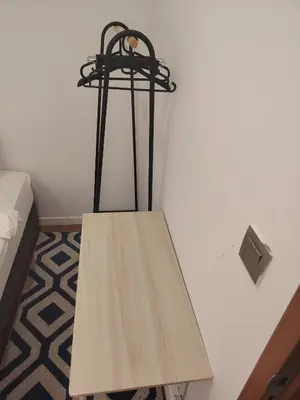 a wooden table in the corner of a room at Sky Suites Apartment service in Kuala Lumpur