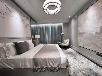 a bedroom with a large bed and a chandelier at Apartment Sixceylon City Centre in Kuala Lumpur
