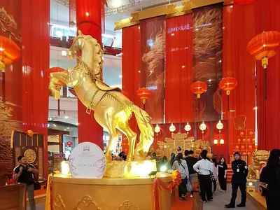 a large gold horse statue in a shopping mall at Time square luxury suites in Kuala Lumpur