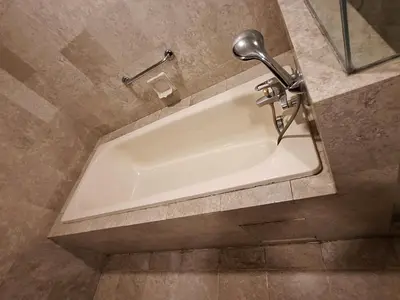 a bath tub in a bathroom with a faucet at Time square luxury suites in Kuala Lumpur