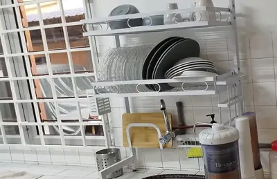 a kitchen with a sink and a shelf with dishes at Segambut Homestay MITEC KLCC PWTC town center in Kuala Lumpur