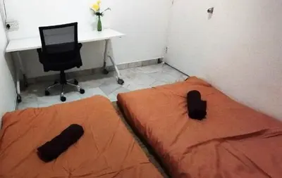 a bedroom with a bed and a desk and a computer at Segambut Homestay MITEC KLCC PWTC town center in Kuala Lumpur