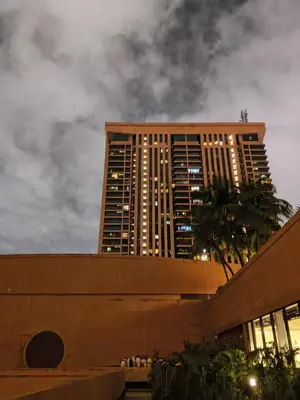 a tall building with a palm tree in front of it at Home land apartment by Times Square in Kuala Lumpur