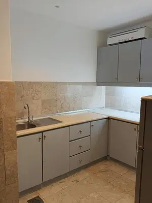 a kitchen with white cabinets and a sink at Home land apartment by Times Square in Kuala Lumpur