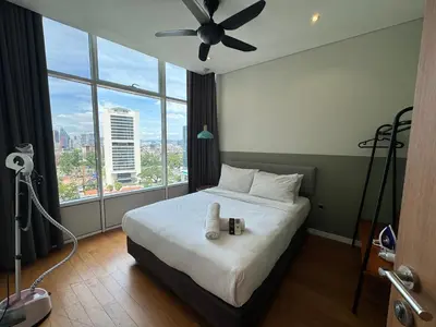 a bedroom with a bed with a ceiling fan at Tomato Homestay in Kuala Lumpur