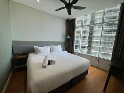 a bedroom with a bed with a ceiling fan and a window at Tomato Homestay in Kuala Lumpur