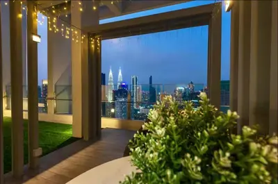 a balcony with a view of a city skyline at Friendly & Cozy Near TRX & Pavilion in Kuala Lumpur
