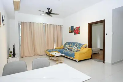 a living room with a yellow couch and a table at Willow Home in Kuala Lumpur