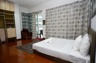 a bedroom with a white bed in a room at Willow Home in Kuala Lumpur