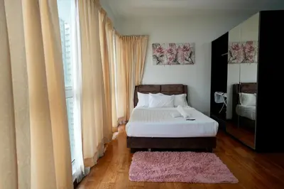 a bedroom with a bed and a large window at Willow Home in Kuala Lumpur