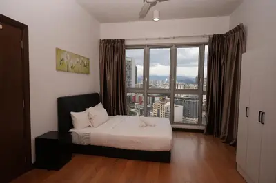 a bedroom with a bed and a large window at Willow Home in Kuala Lumpur