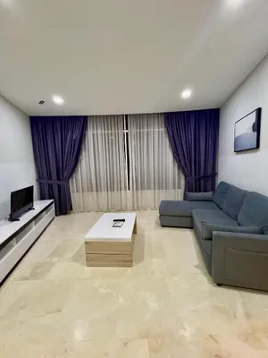 a living room with a blue couch and a tv at Vortex suites klcc by ARICA in Kuala Lumpur