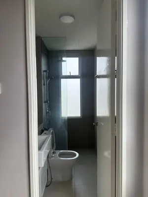 a bathroom with a toilet and a sink and a window at Desa green unit in Kuala Lumpur