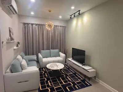 a living room with a couch and a tv at Desa green unit in Kuala Lumpur