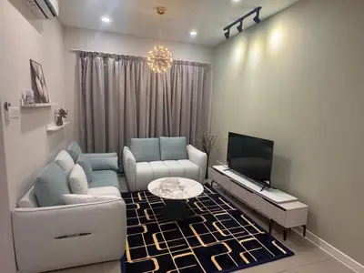 a living room with a couch and a tv at Desa green unit in Kuala Lumpur