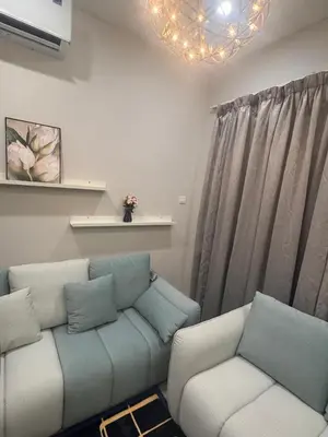 a living room with a couch and two chairs at Desa green unit in Kuala Lumpur