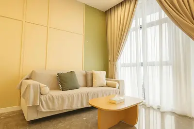 a living room with a couch and a table at Royce Residence KLCC twin tower by ABM Unique in Kuala Lumpur