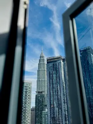 a view of a city skyline from a window at Royce Residence KLCC twin tower by ABM Unique in Kuala Lumpur