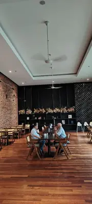 two men sitting at a table in a restaurant at Chambers suites KLCC by Infinity in Kuala Lumpur