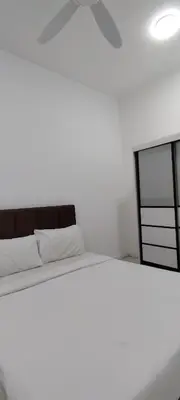 a white bedroom with a bed and a ceiling fan at Chambers suites KLCC by Infinity in Kuala Lumpur