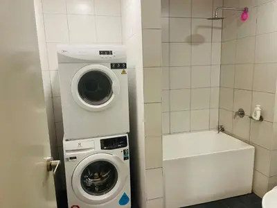 a washer and dryer in a small bathroom at Chambers suites KLCC by Infinity in Kuala Lumpur