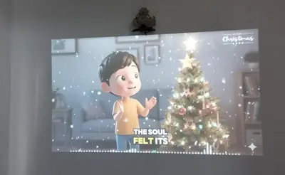 a tv screen with a child standing in front of a christmas tree at Segambut Homestay MITEC KLCC PWTC 13 paxs in Kuala Lumpur