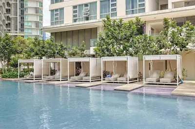 a hotel with a pool in front of a building at Robertson Residence by Aspire Suites in Kuala Lumpur